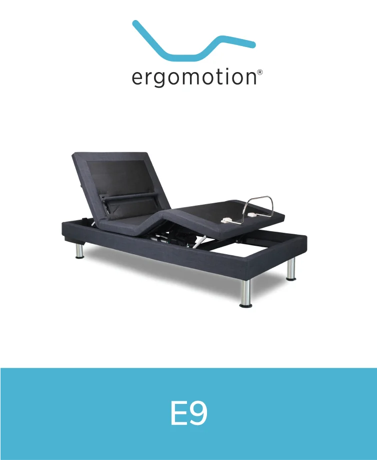 Ergomotion E9 adjustable bed featuring a gray base and headboard with visible control panel