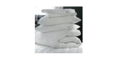 A selection of fluffy comforters with different fill materials on display